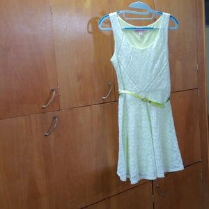 White lace dress with neon yellow lining and belt